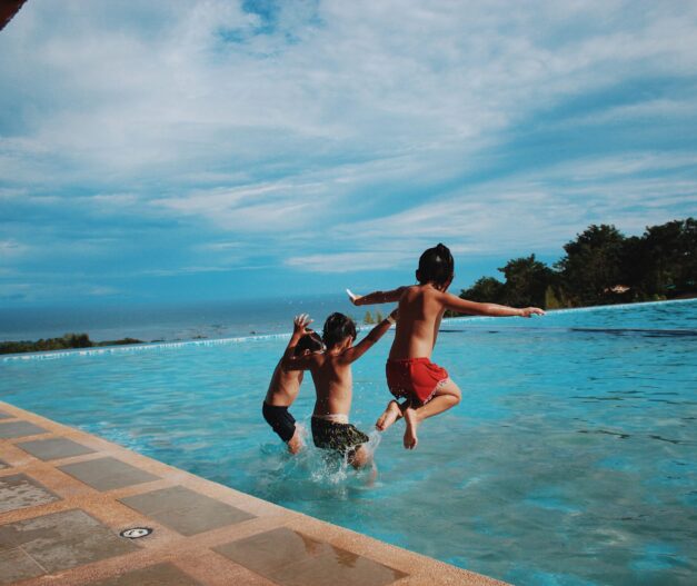 kids jumping in pool